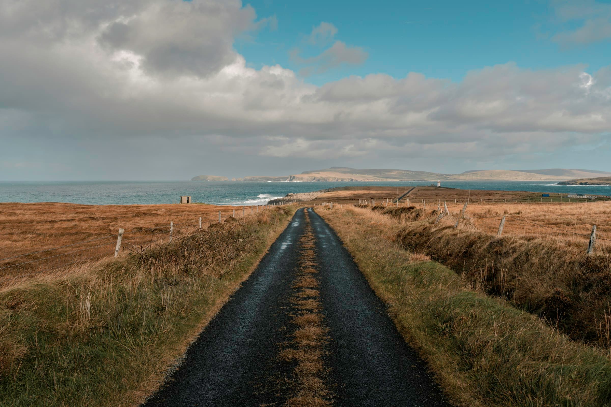 A path through Irish moorland leading toward the sea