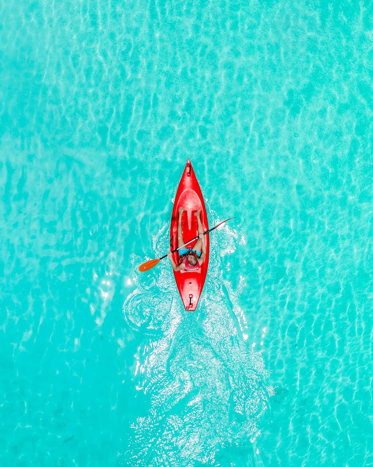 Kayakers on bright turquoise water